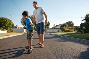 man and his son on a skateboard