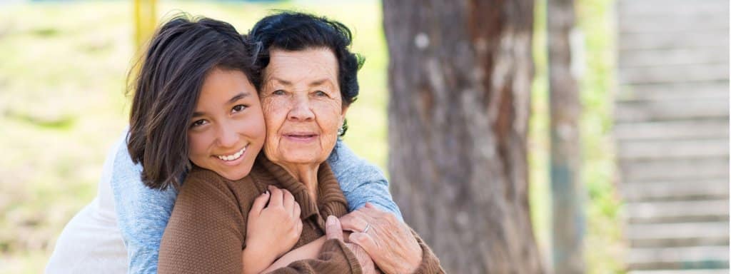 Young girl hugging grandmother