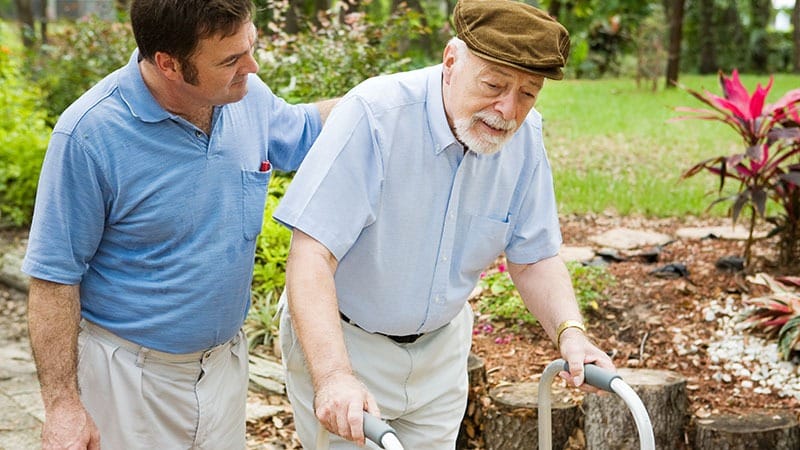 caregiver helps senior man who needs respite care