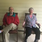 senior man and senior woman sit on chairs