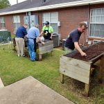 staff prepares soil for gardening