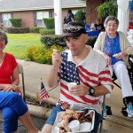 man in t-shirt with USA flag eats