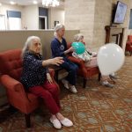 residents play with balloons